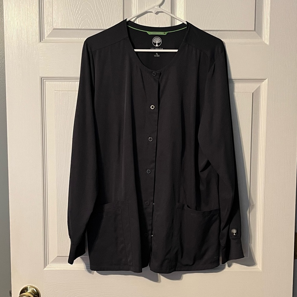 Gray Healing Hands scrub jacket.